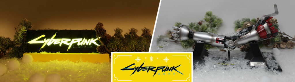 Dans le thème de Noël et présentés comme des cadeaux, une lampe fait avec le logo de Cyberpunk 2077 et une réplique du bras de Johnny Silverhand. le logo se trouve au premier plan, en bas au centre.